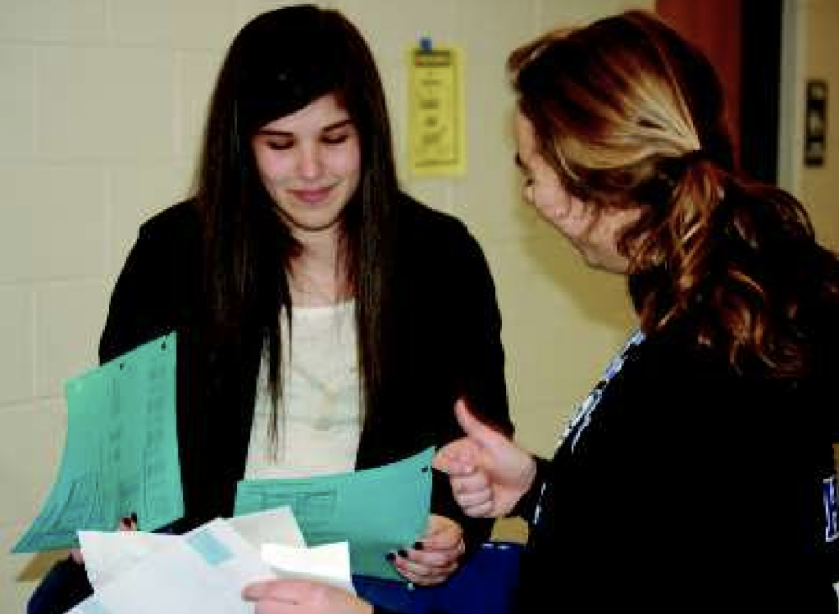 On a Friday afternoon, sophomores Rebecca Carroll and Amy Mautz sort
papers. Papers are collected every Friday to be recycled by the
Environmental Club.